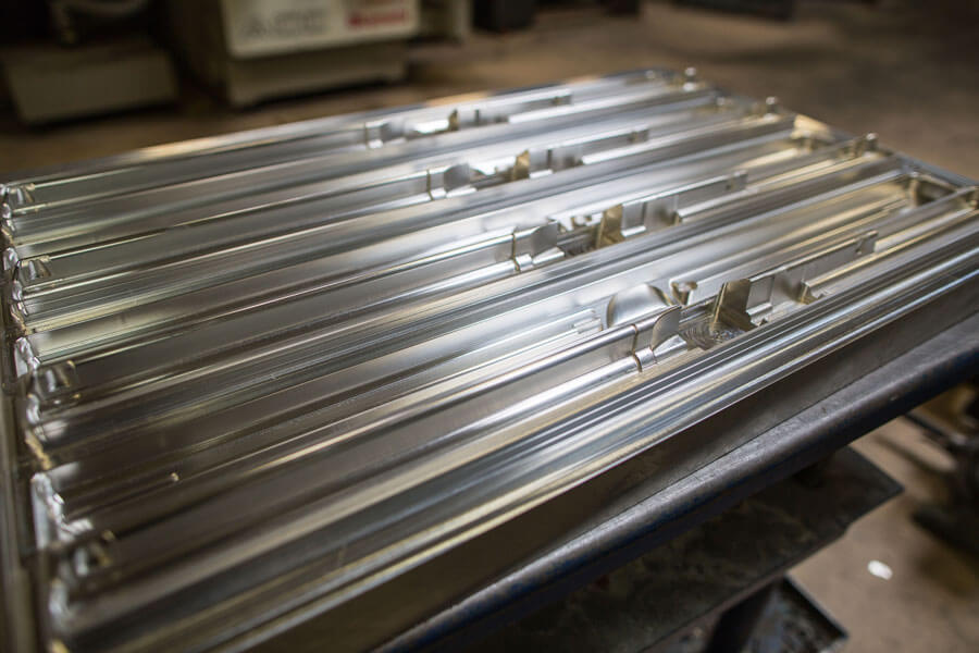 Metal coatings lined up next to each other on a table