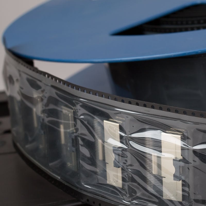 Plastic Covers A Roll of NEPTCO Cover Tape In A Blue Spool