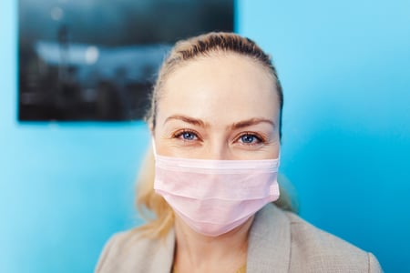 Close up of tek pak worker with a pink mask on