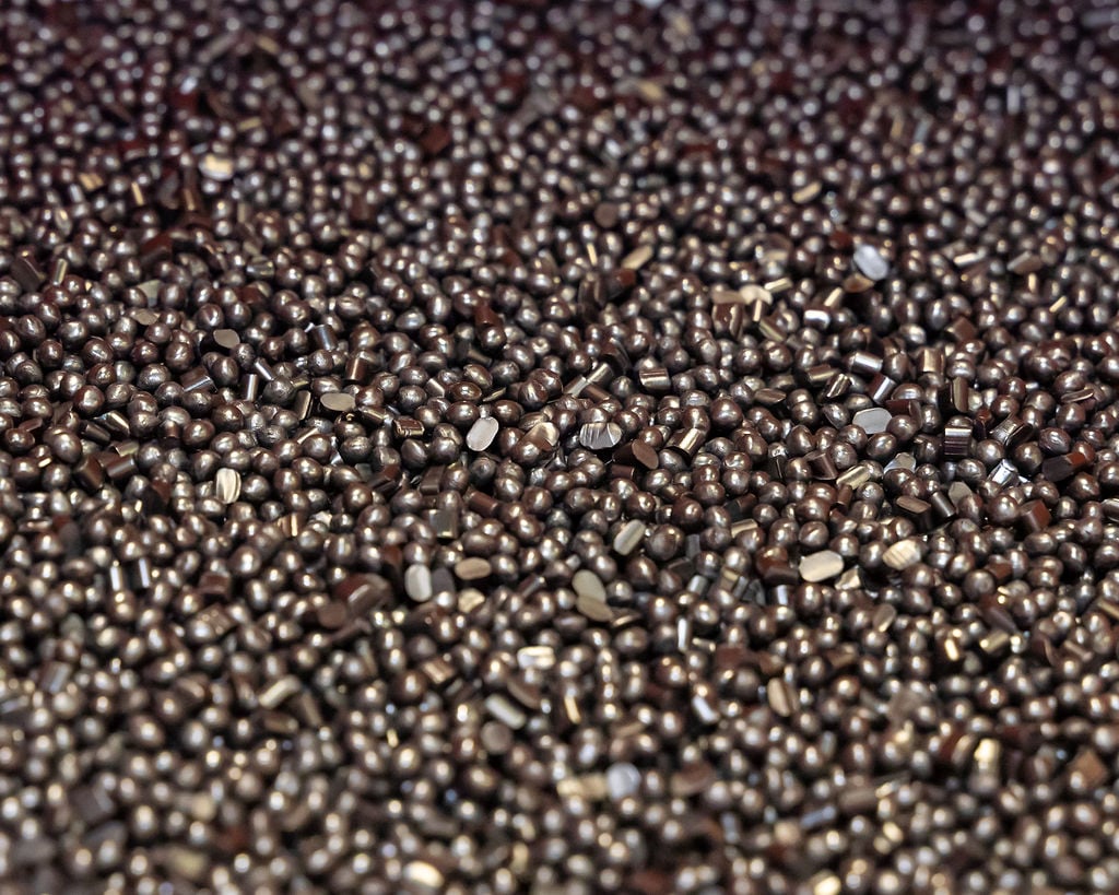 Small metal beads or pellets that get melted down before used in the thermoforming and fiber molding process