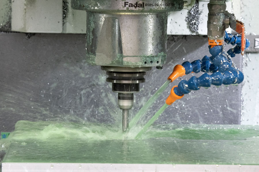 Thermoform tooling drill with green liquid being applied