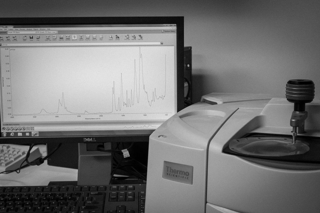 Black and white photo of a thermo scientific machine analyzing the quality of a film thermoformed tool